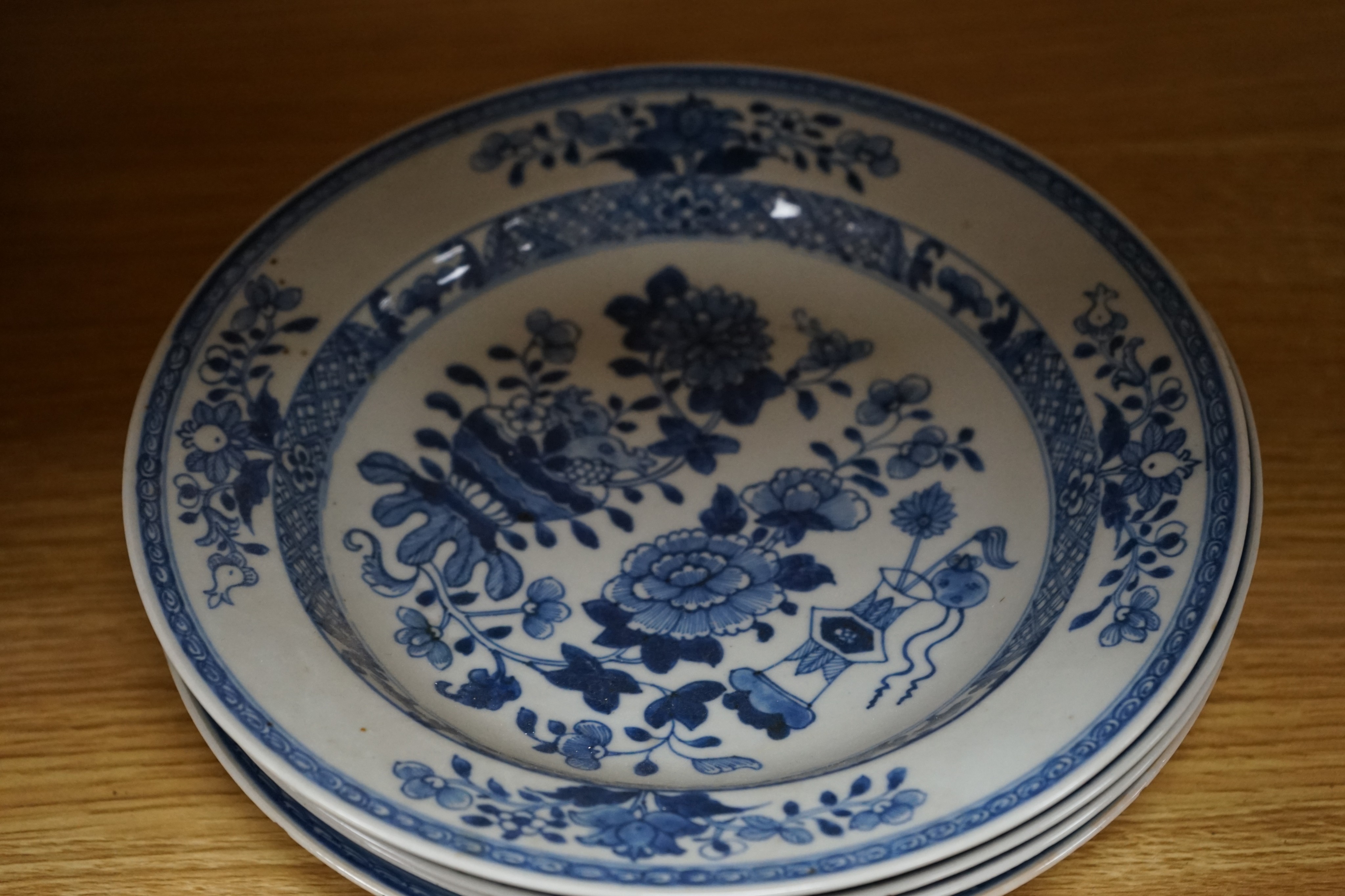 An 18th century Chinese Export blue and white octagonal tureen and cover, decorated with birds and flowers, a pair of similar sauceboats and five plates decorated with urns of flowers